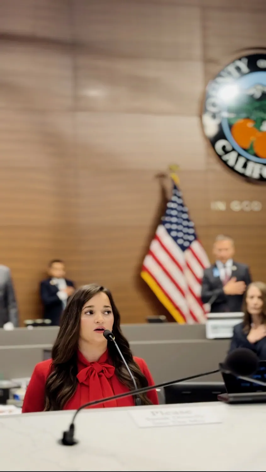 Alissa speaking in a formal public setting
